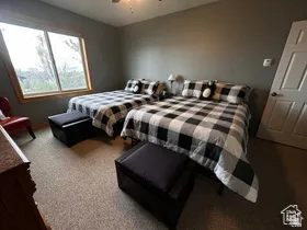 Bedroom featuring a ceiling fan and carpet flooring