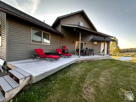Rear view of property with a yard and a patio