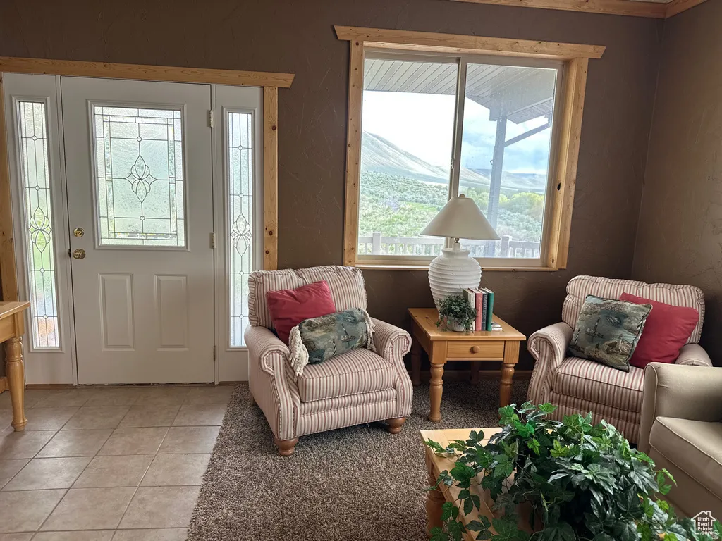 Foyer entrance with light tile patterned floors and plenty of natural light