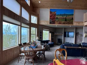 Dining room featuring wood walls, plenty of natural light, carpet flooring, a high wood ceiling, and recessed lighting
