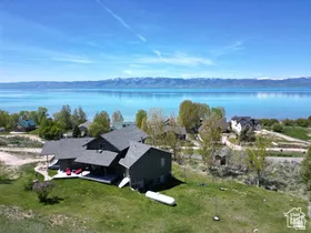 Aerial view of property and surrounding area with a nearby body of water