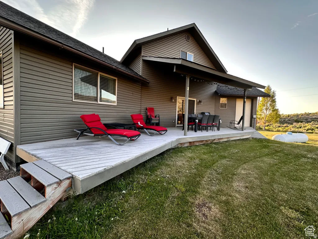 Rear view of house featuring a lawn and a patio