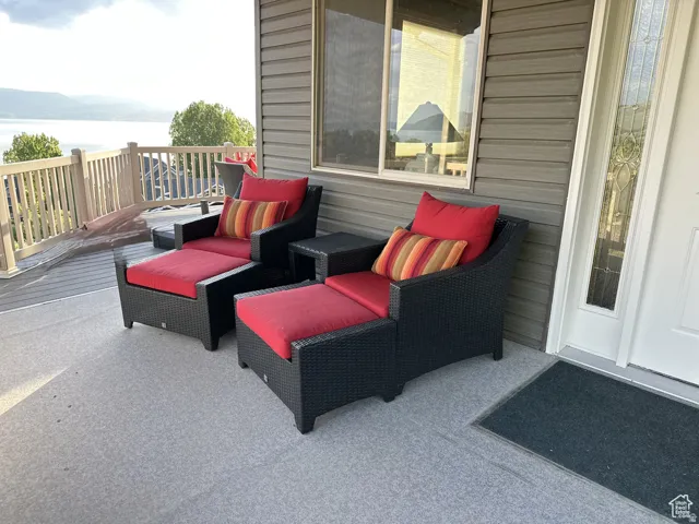 View of patio / terrace featuring a deck with water view