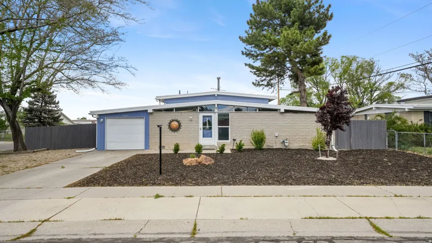 Charming mid-century inspired exterior with xeriscape landscaping, offering a stylish, low-maintenance yard designed for efficiency and year-round curb appeal. A perfect blend of character and practicality in a convenient  location.