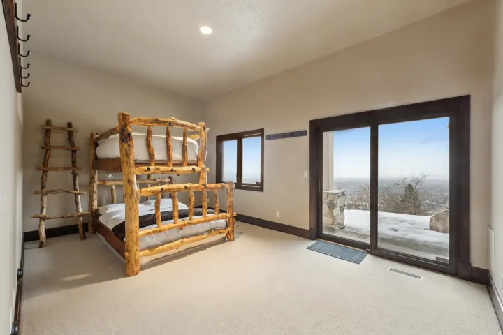 Bedroom featuring light carpet and access to exterior
