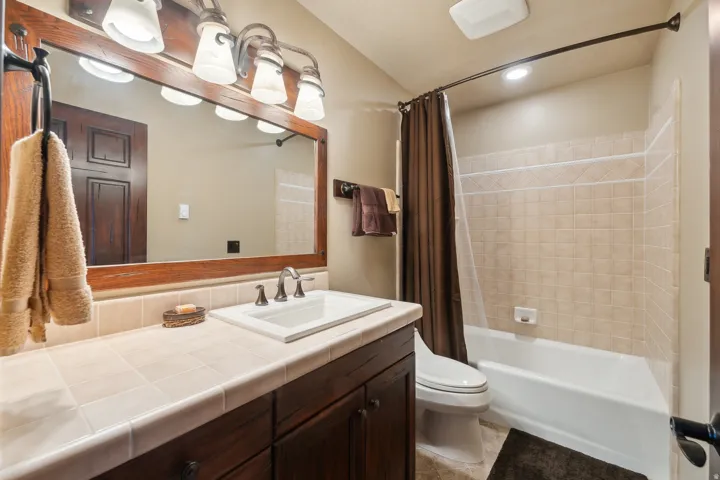 Full bathroom featuring vanity and shower / bath combination with curtain