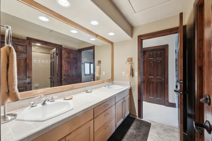 Bathroom featuring double vanity, recessed lighting, and curtained shower