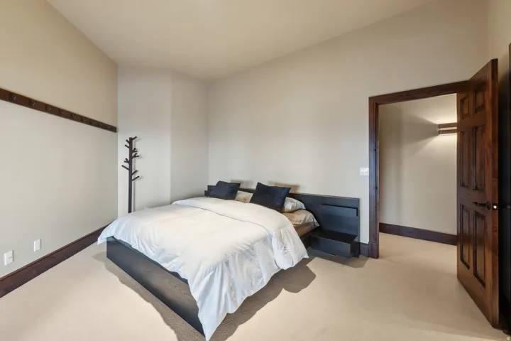Bedroom with light carpet and baseboards