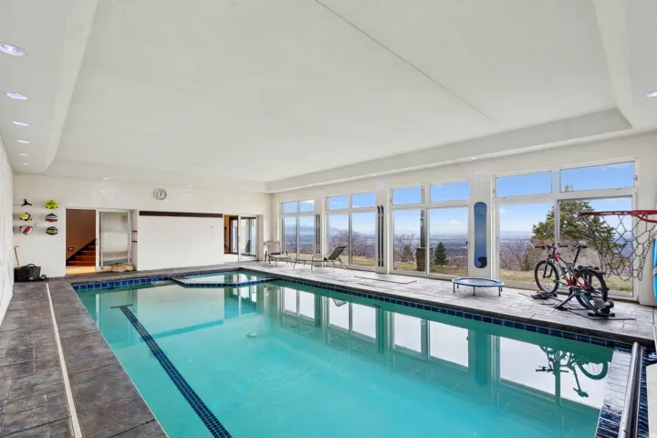 Indoor pool featuring a sunroom
