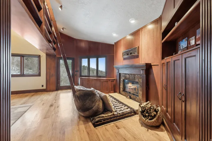Wood burning fireplace in master bedroom library area for reading and entertaining.