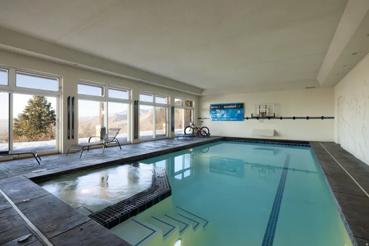 Integrated pool / hot tub featuring a mountain view