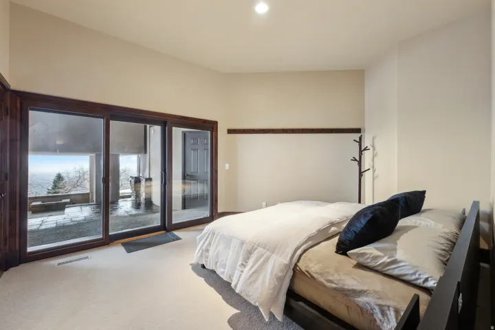 Bedroom featuring light carpet, access to exterior, and recessed lighting