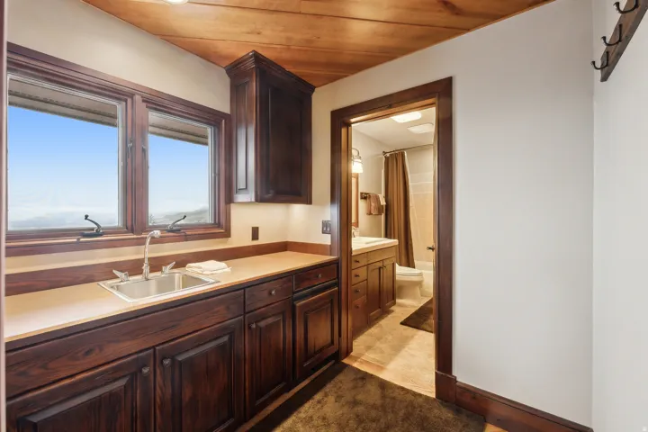 5th bedroom kitchenette with mini frig below & full bath in background.