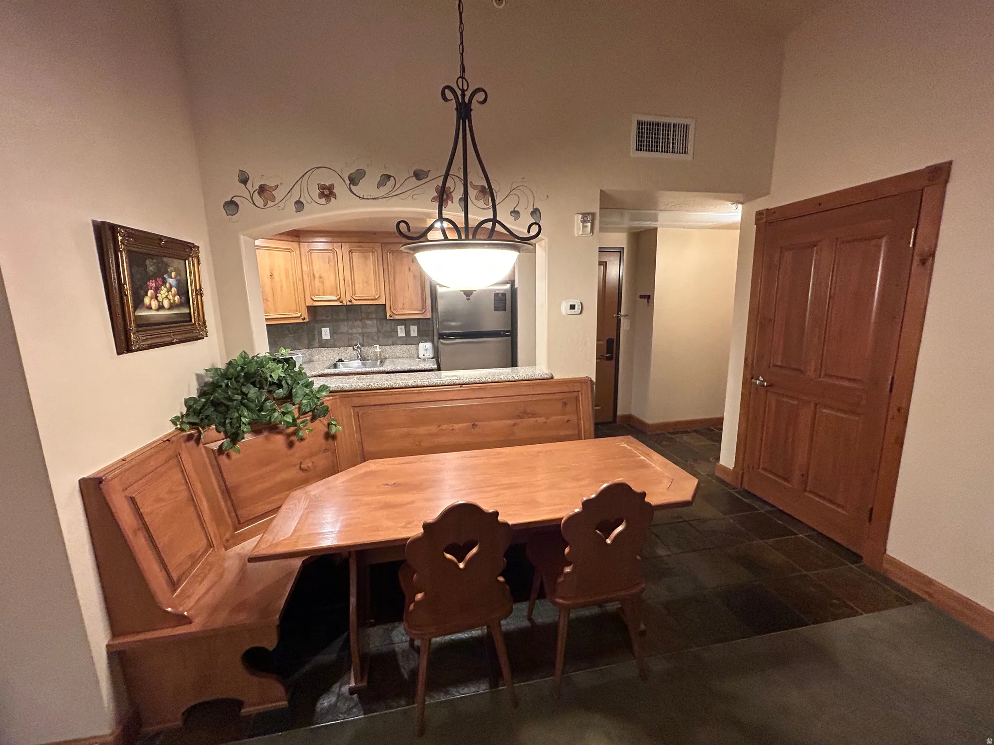 Dining area with baseboards and a high ceiling