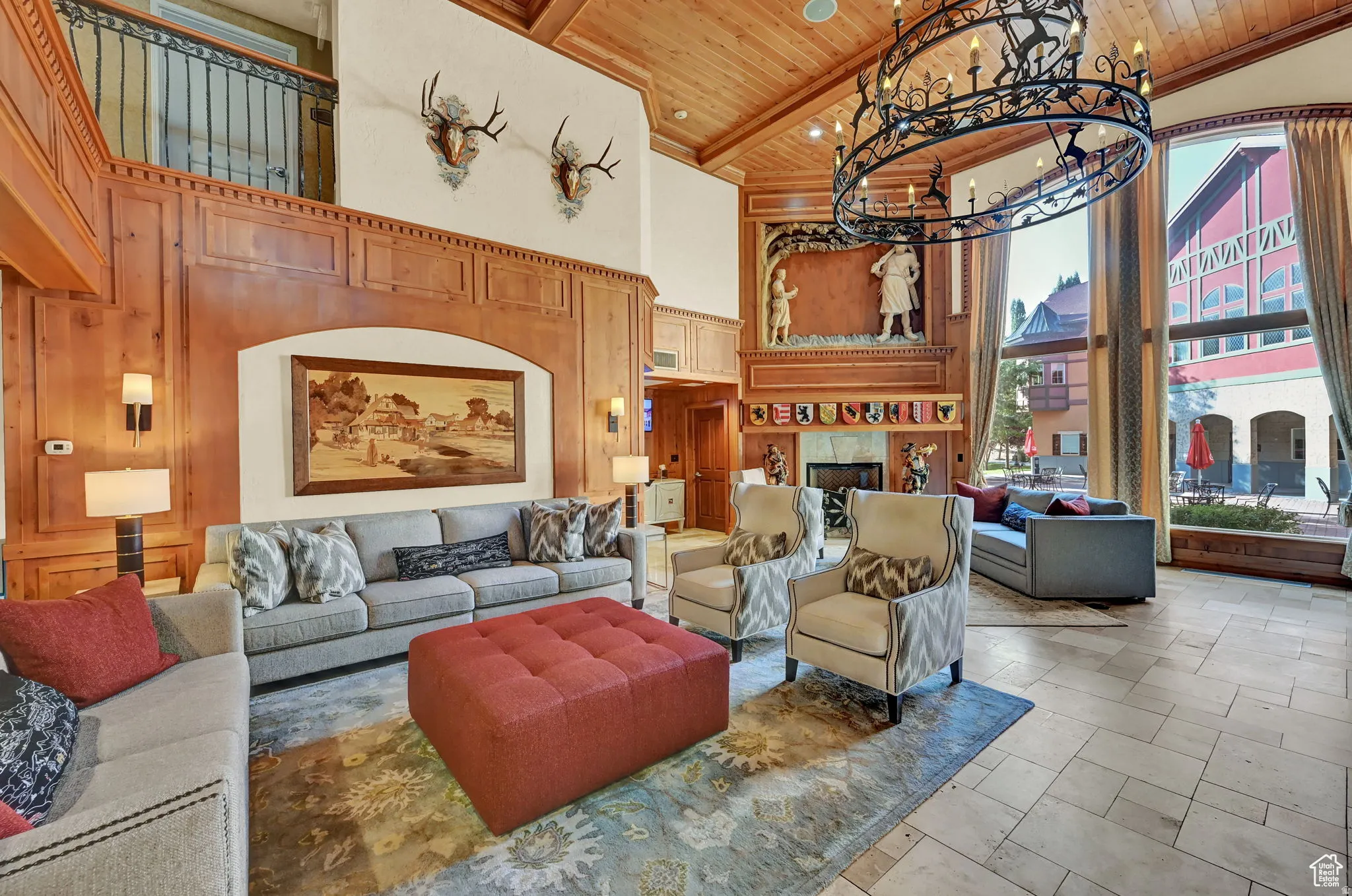 Building lobby featuring a high wood ceiling, wood walls, and recessed lighting