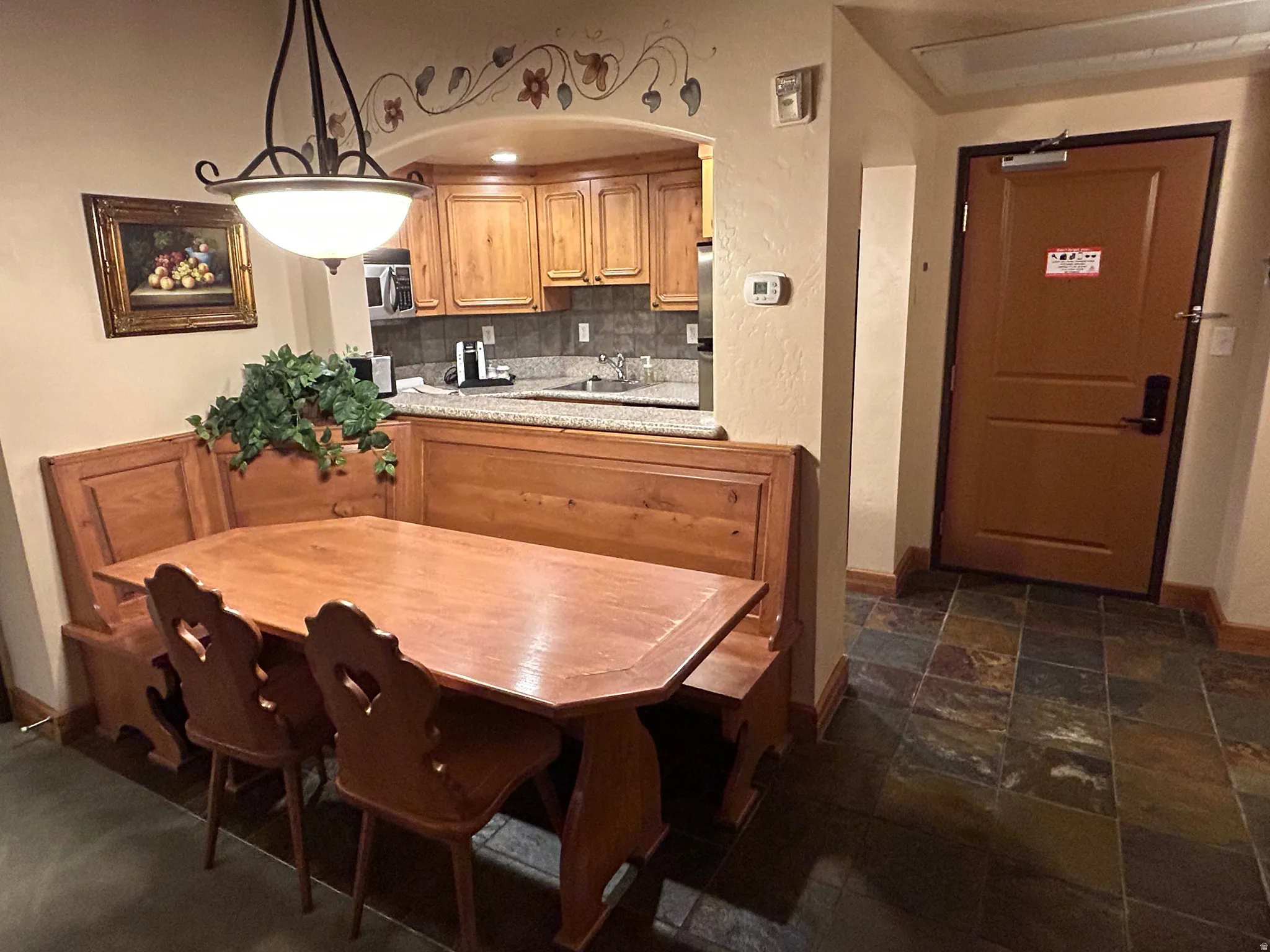 Dining area featuring arched walkways and stone tile floors