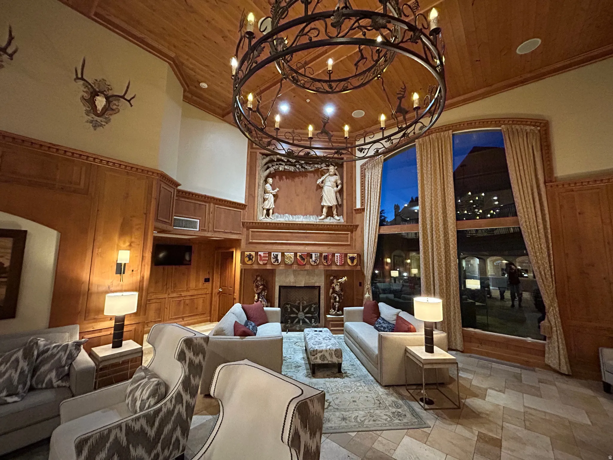 Common area with wooden walls and a high wooden ceiling