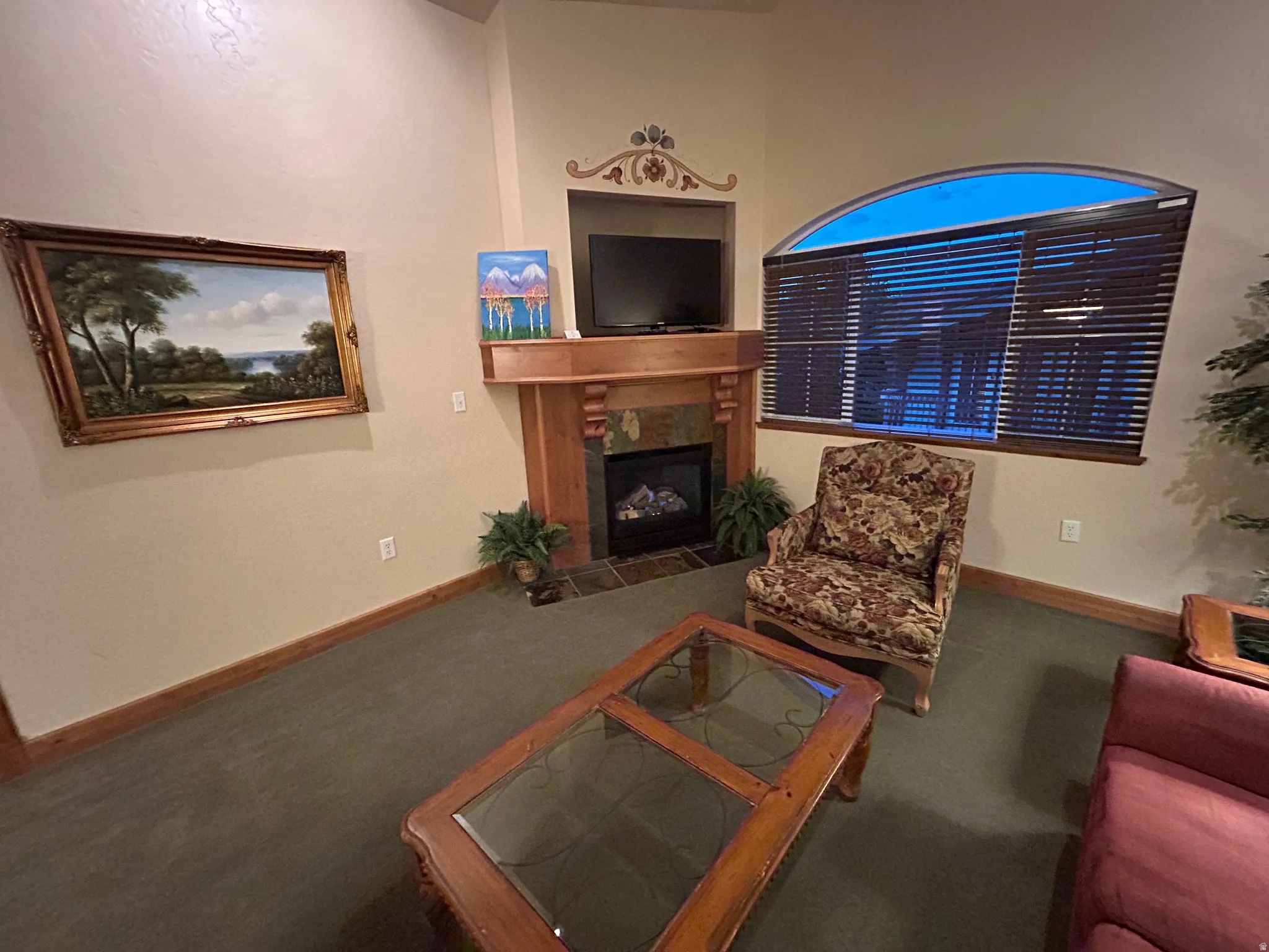 Living room featuring a fireplace and carpet floors