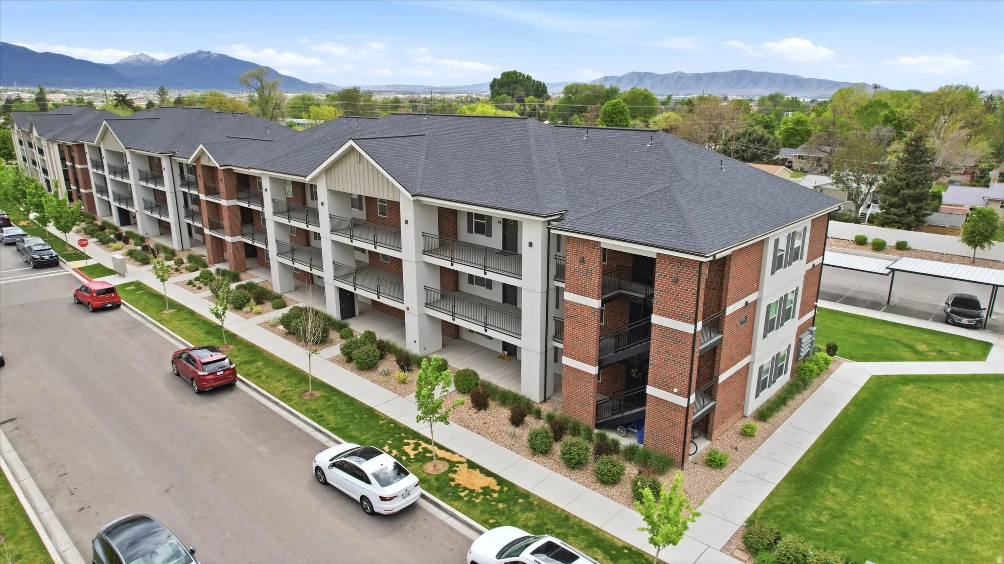 View of property featuring a mountain view and uncovered parking