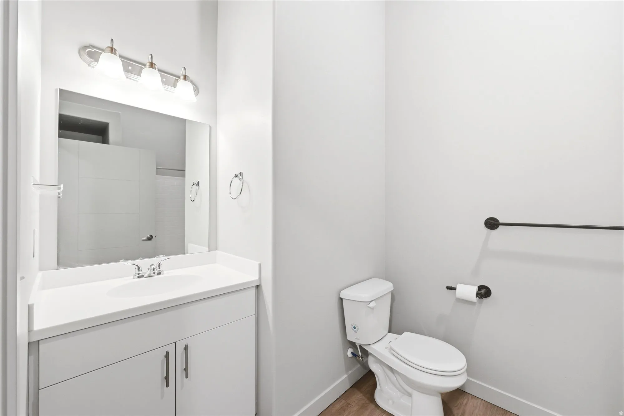 Full bathroom featuring vanity and light wood-type flooring