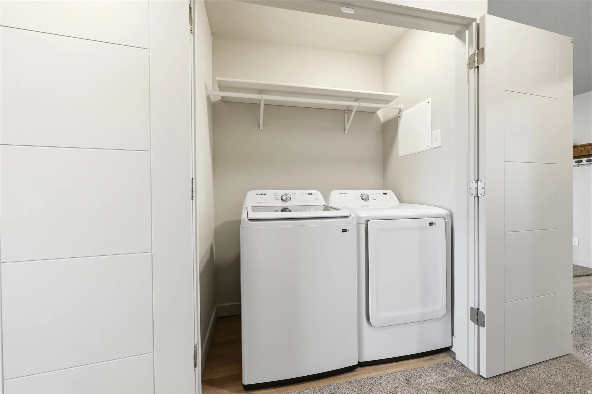 Laundry area featuring washer and dryer and baseboards