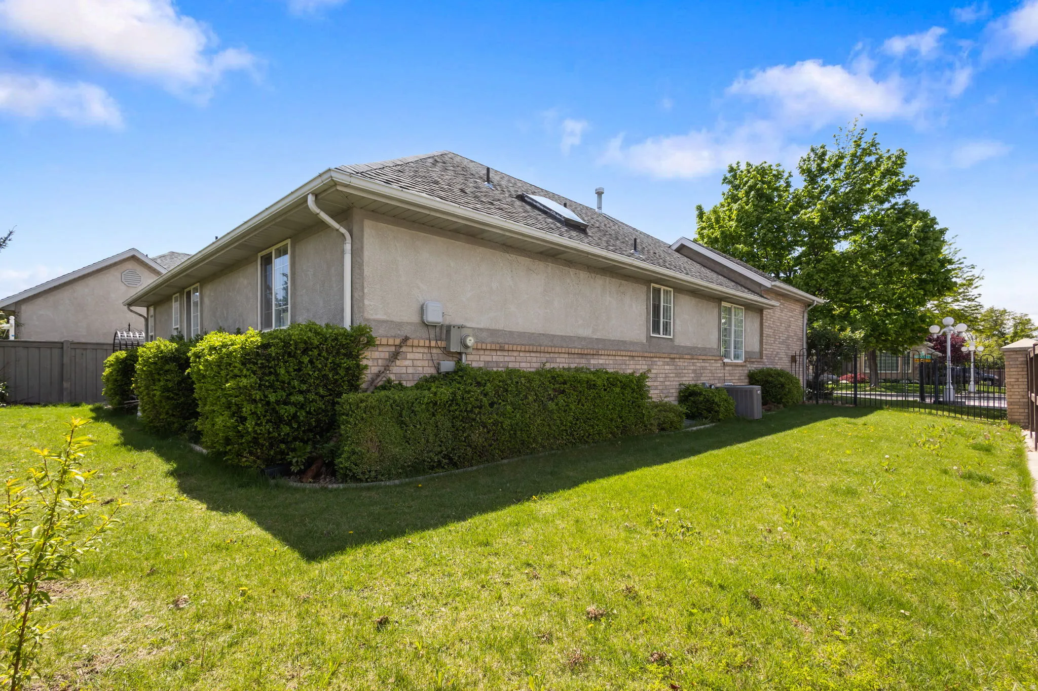 View of side of property featuring brick siding and stucco siding