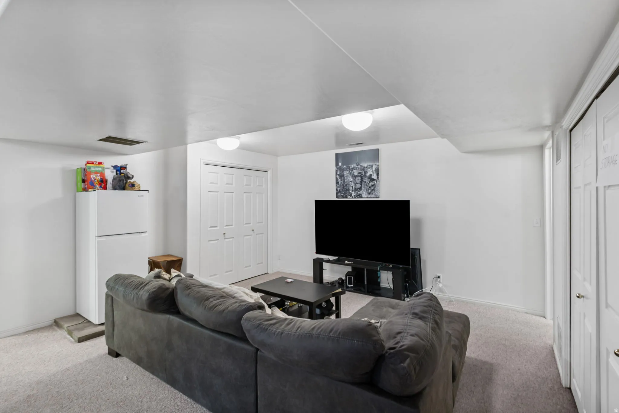 Carpeted living area featuring baseboards