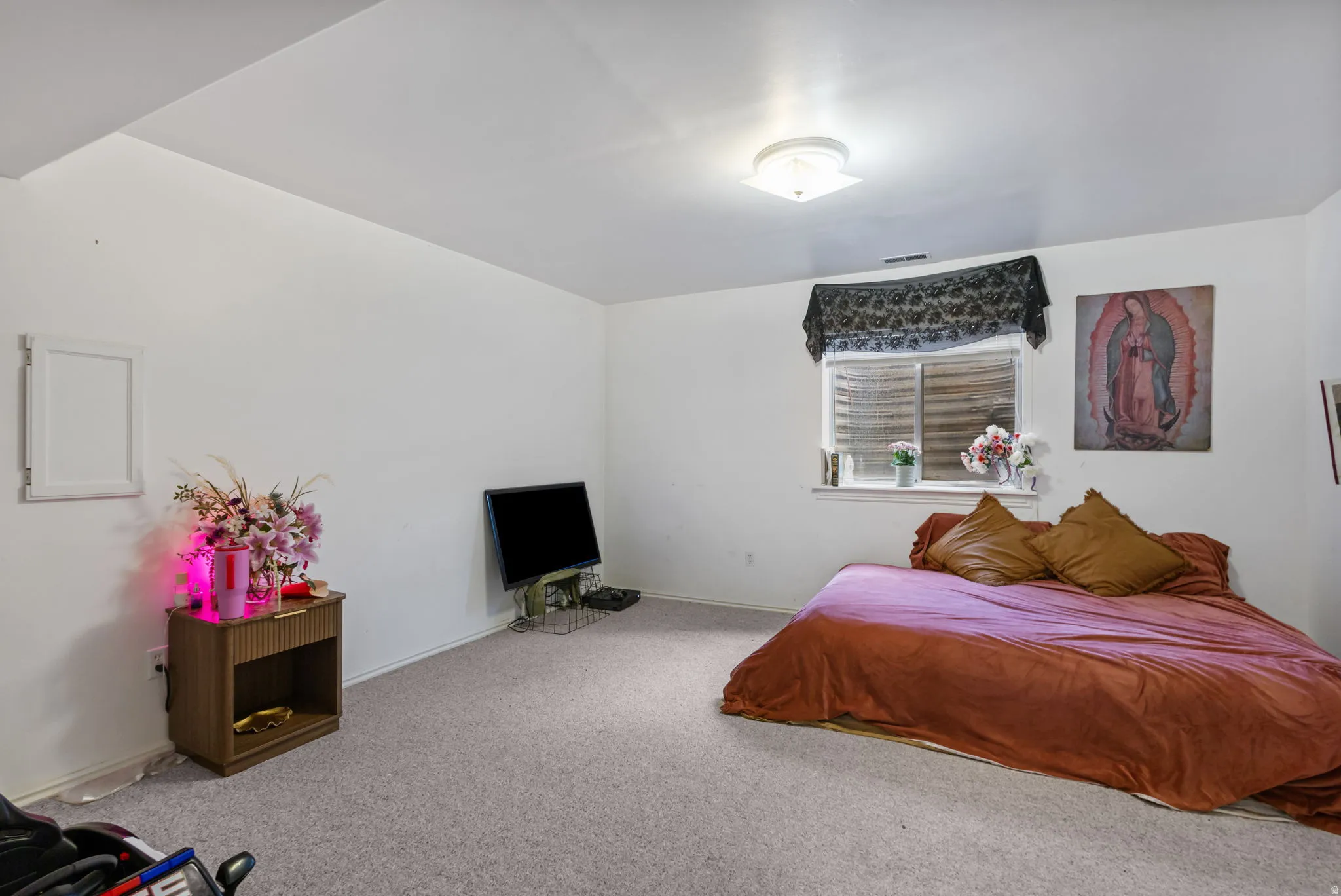 Carpeted bedroom featuring baseboards