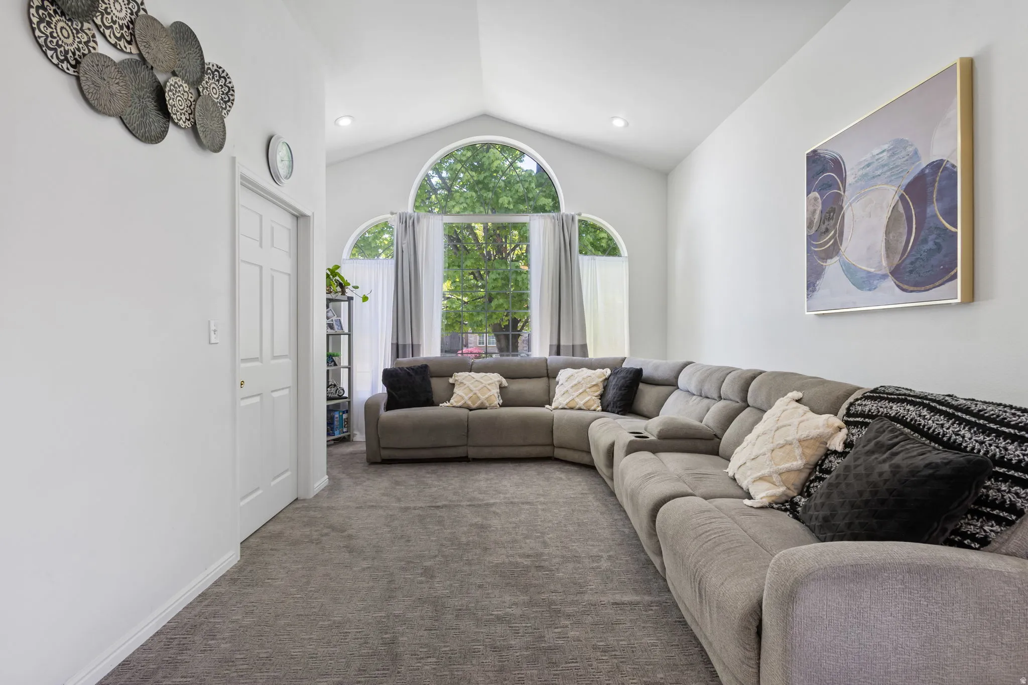 Carpeted living room with recessed lighting and baseboards