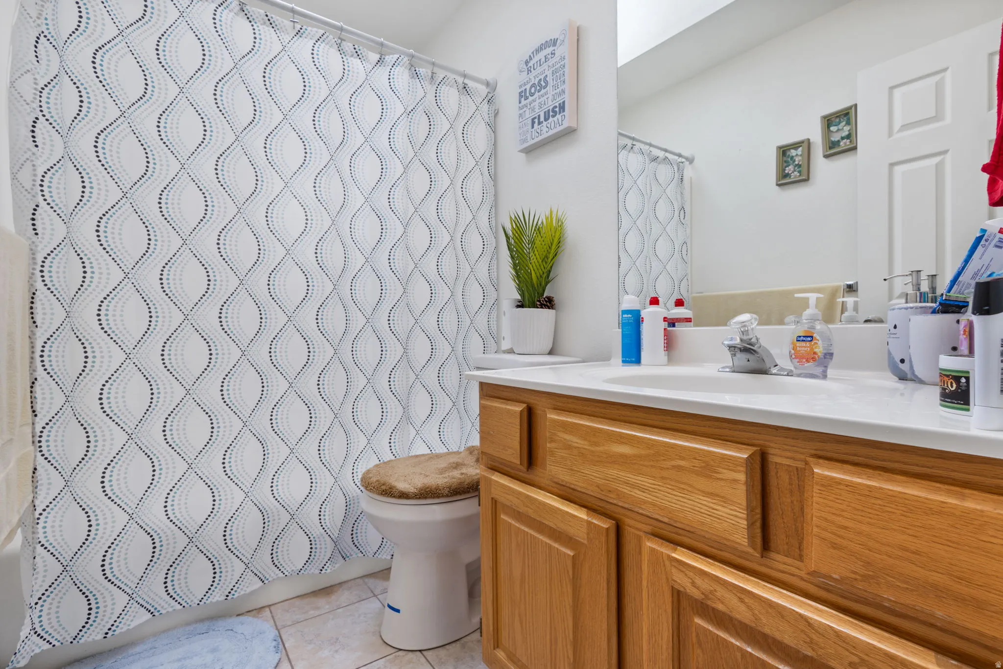 Bathroom with vanity and light tile patterned flooring