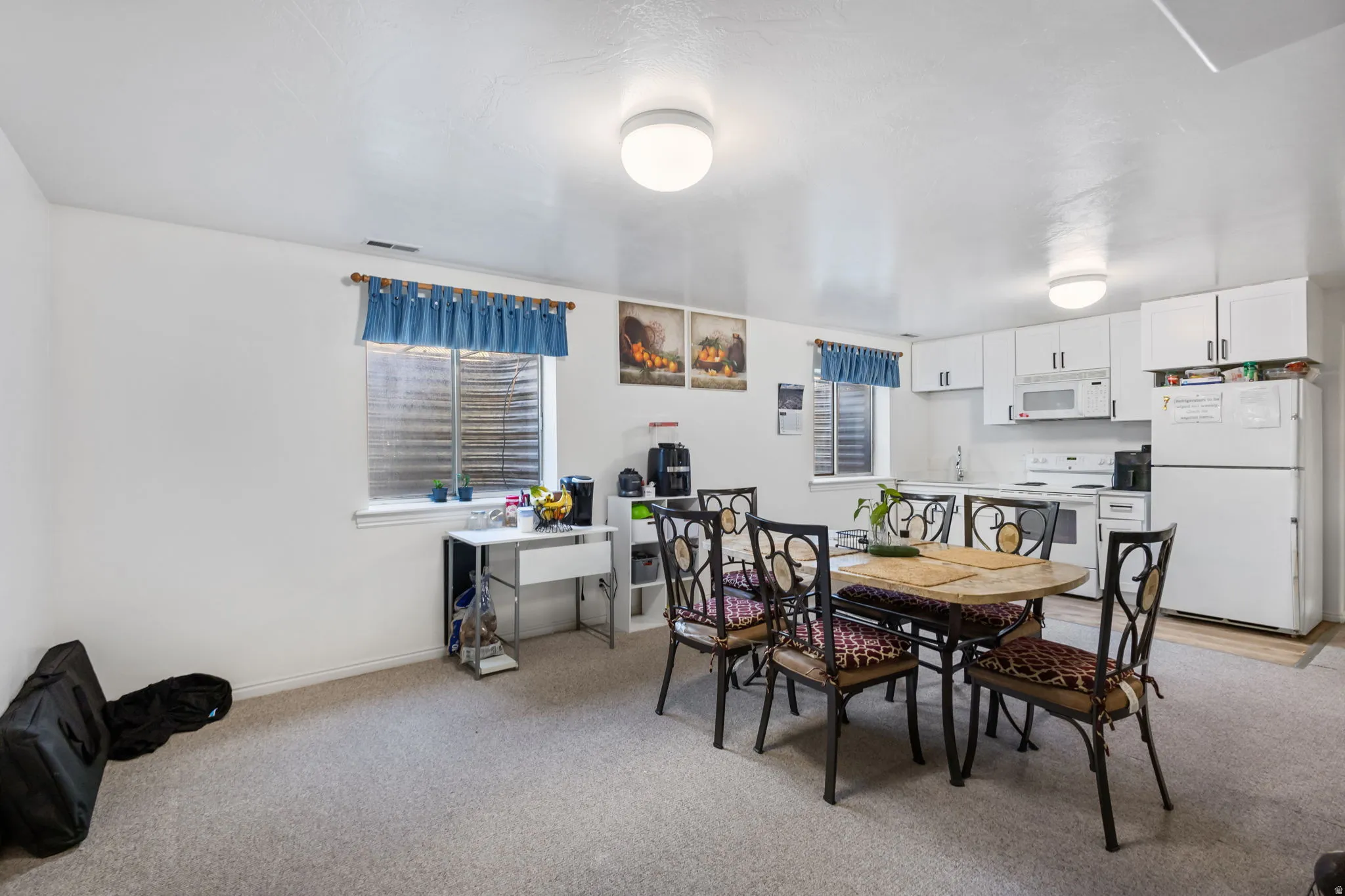 Dining area featuring healthy amount of natural light and light colored carpet