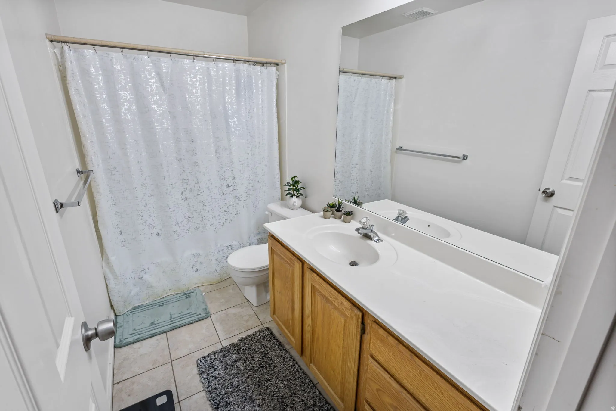 Full bathroom featuring vanity and light tile patterned floors