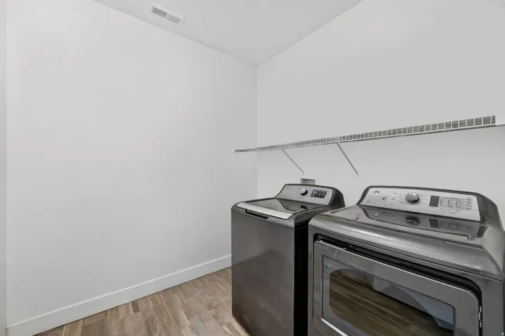 Laundry room with light wood-style floors and separate washer and dryer