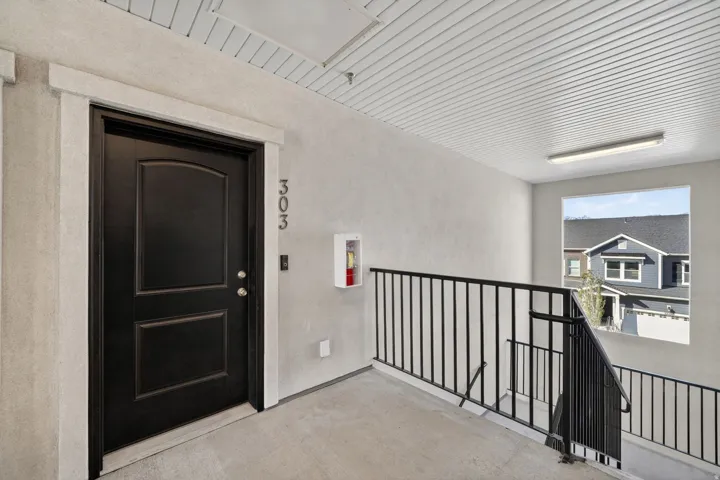 Property entrance featuring stucco siding