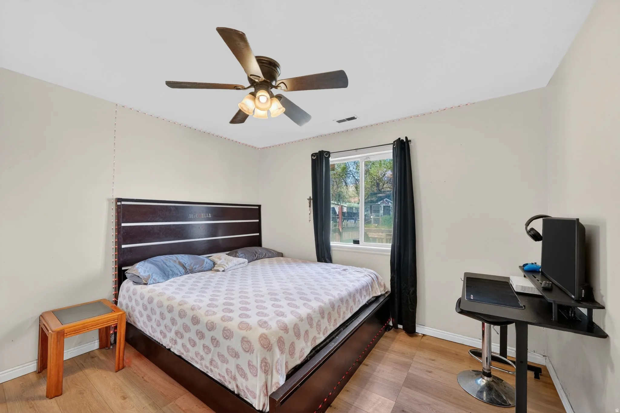 Bedroom with light wood-style flooring and a ceiling fan