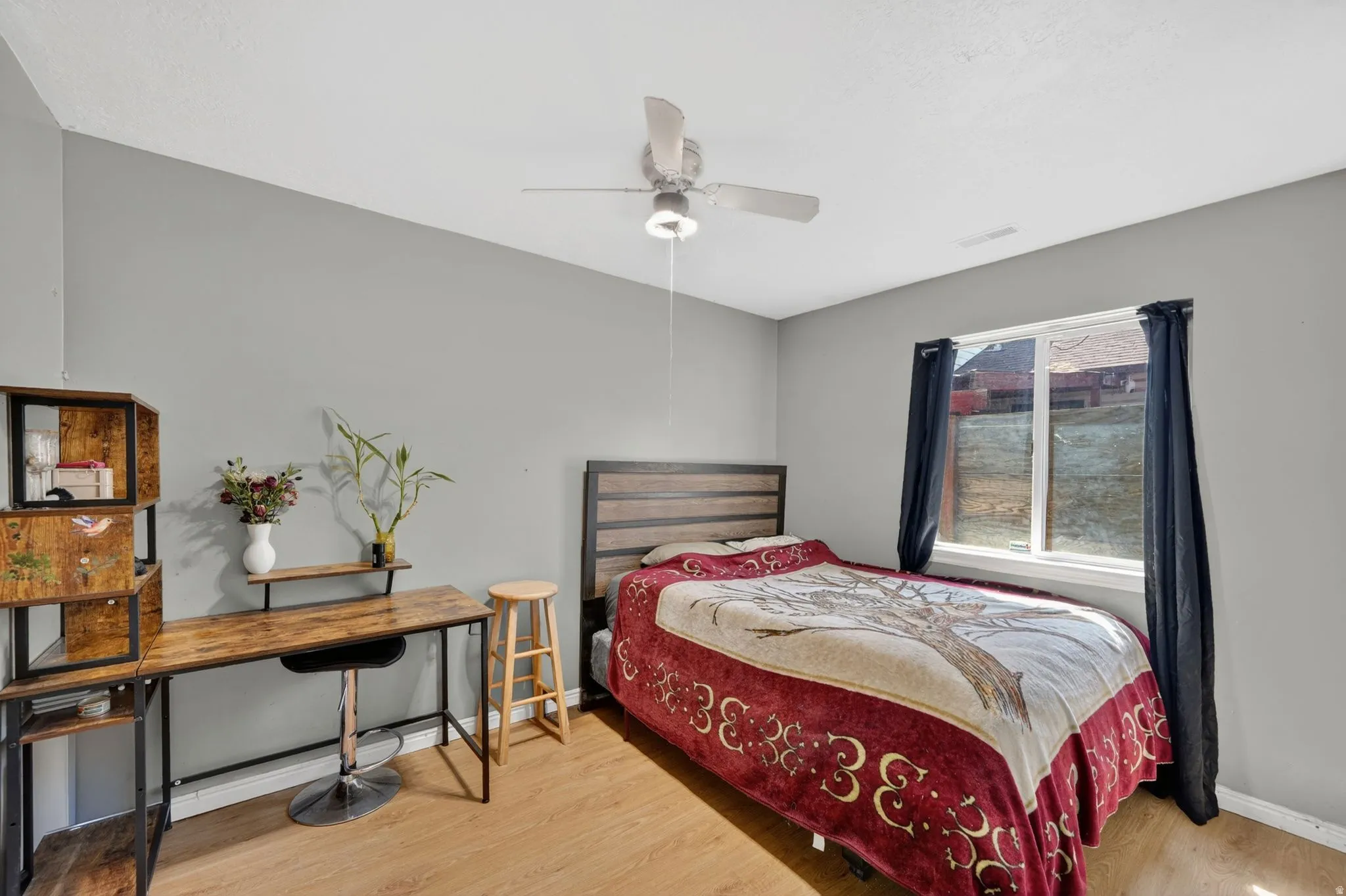Bedroom featuring light wood finished floors and a ceiling fan