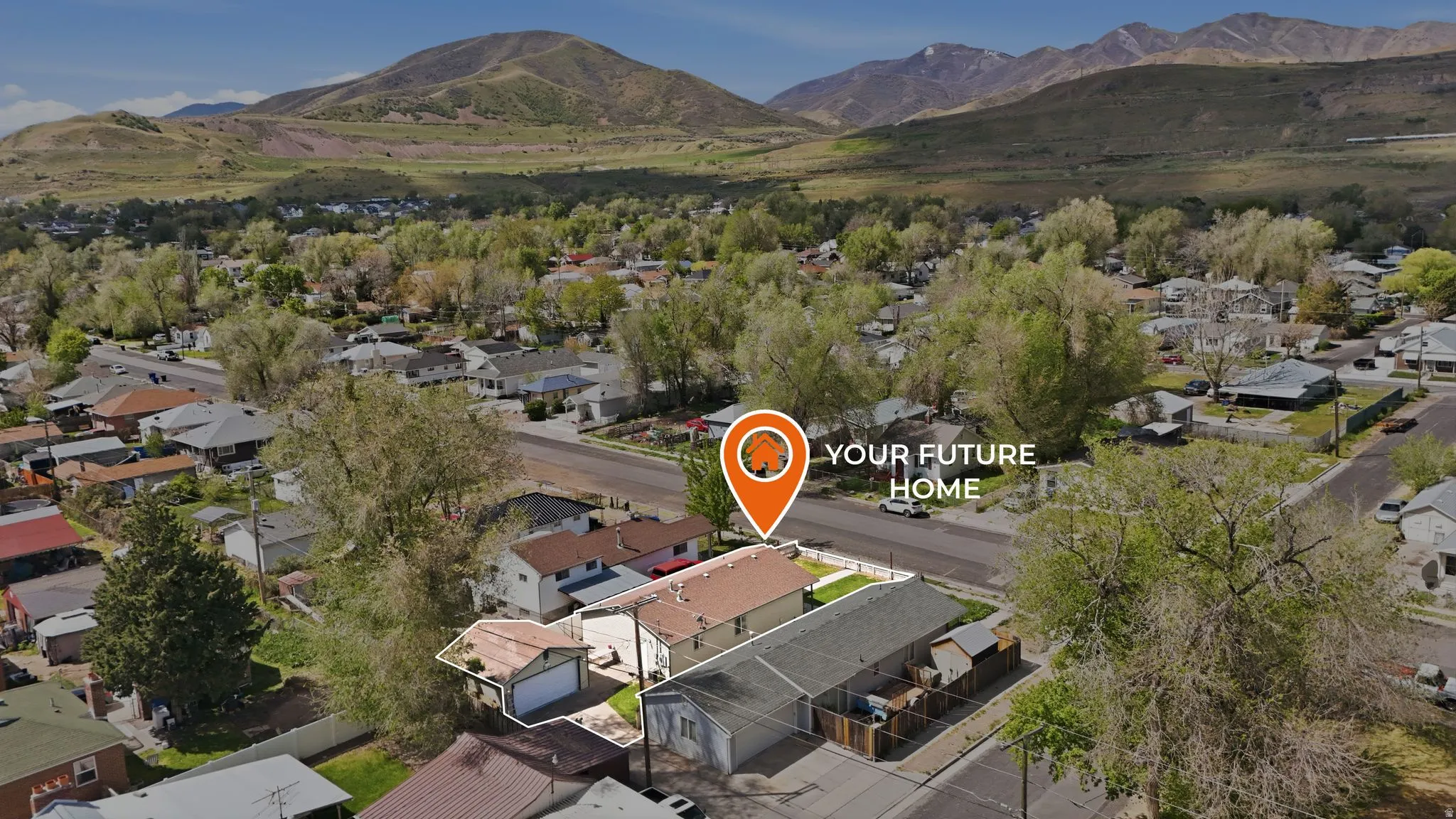 Aerial view of residential area featuring a mountainous background