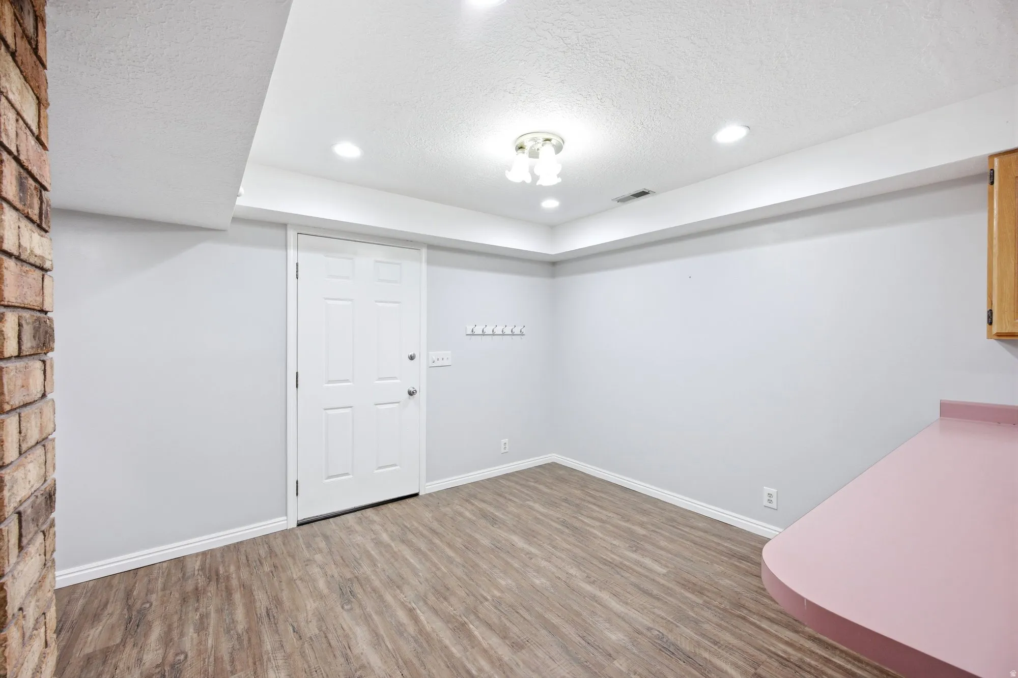 Exterior entrance for basement studio apartment and dining table area