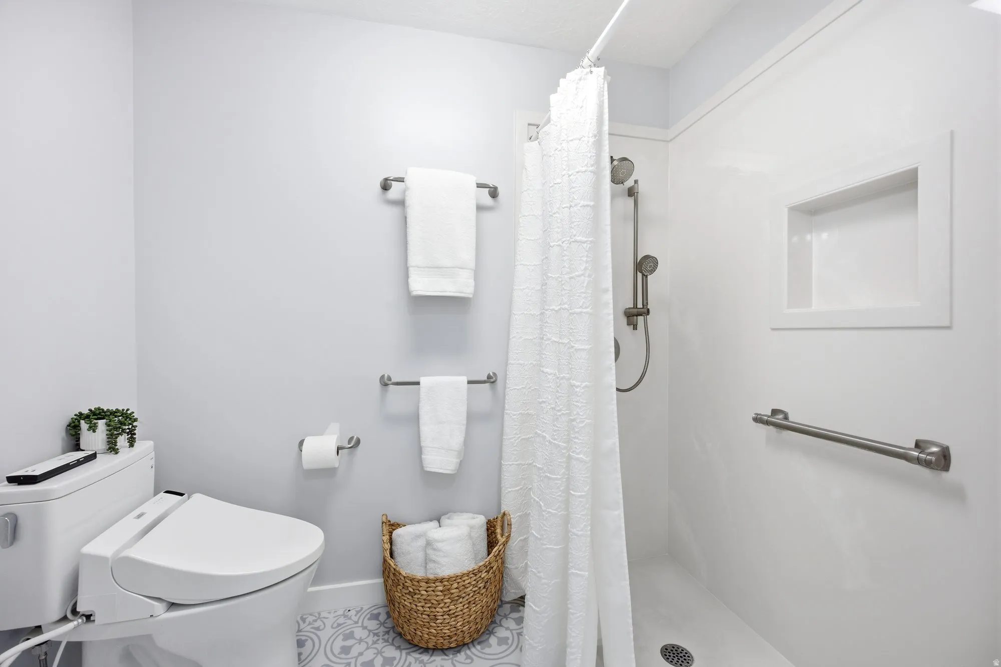 Large primary suite shower area,  featuring a spa like walk in shower.