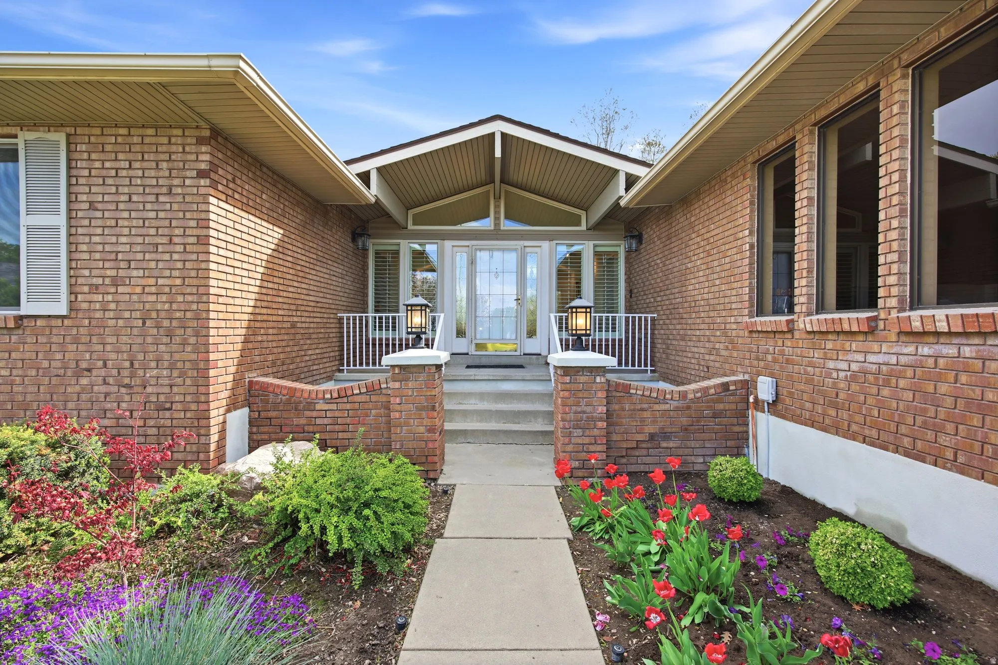 Front door, porch and flower beds