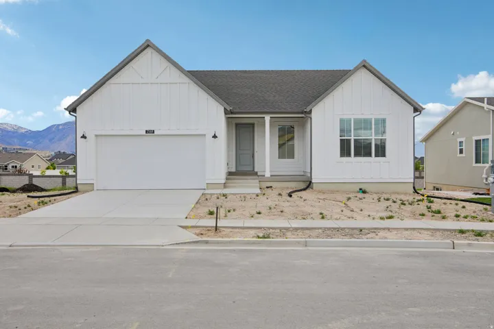 View of front of home featuring board and batten siding, a porch, an attached garage, concrete driveway, and a shingled roof