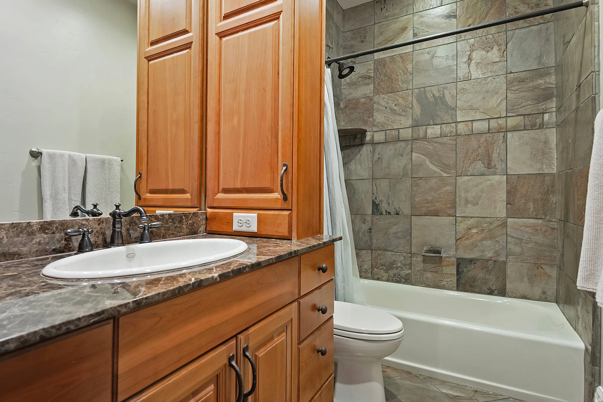 Full bath with vanity and shower / bath combo with shower curtain