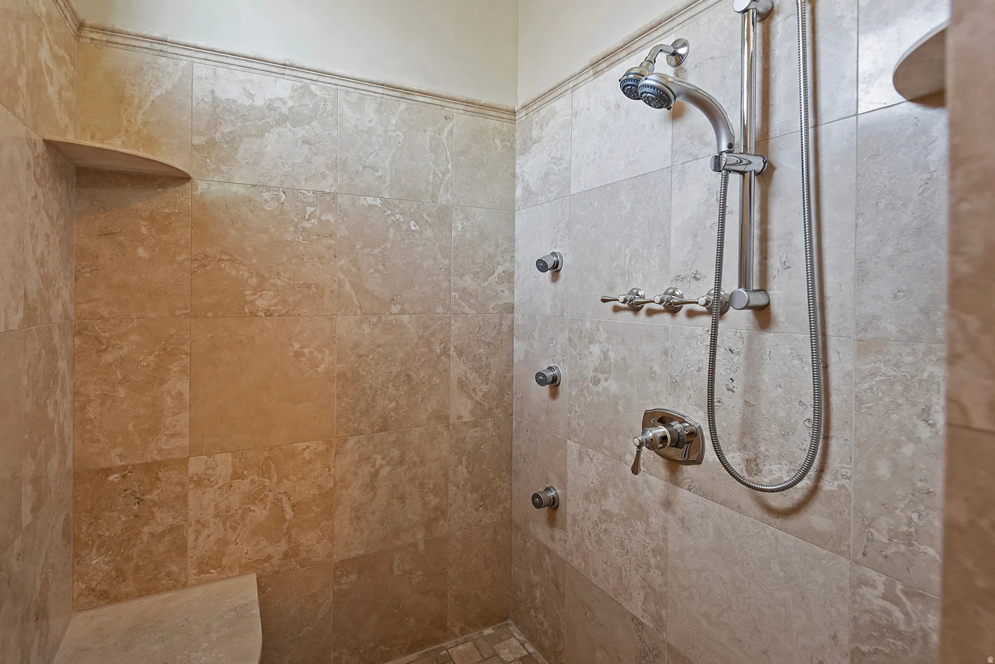 Full bath featuring tiled shower