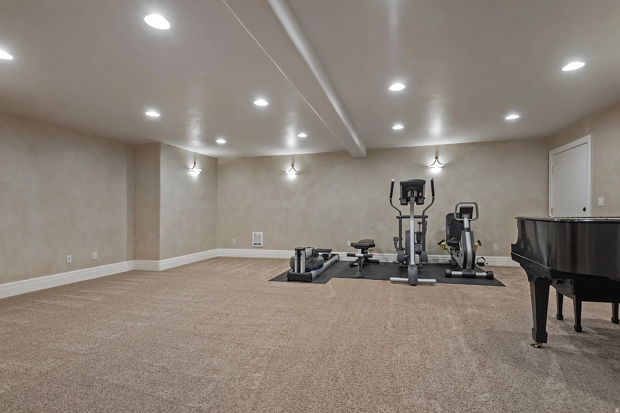 Workout area with recessed lighting, light colored carpet, and beam ceiling