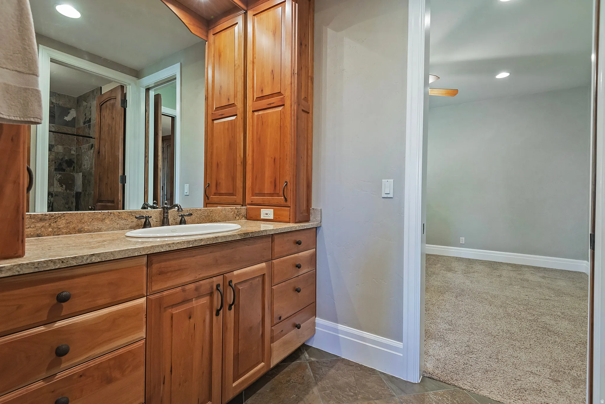 Full bath with vanity, recessed lighting, and dark carpet
