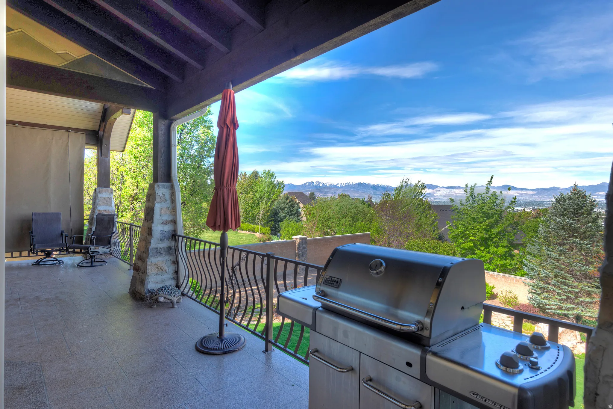 View of patio with a mountain view and area for grilling