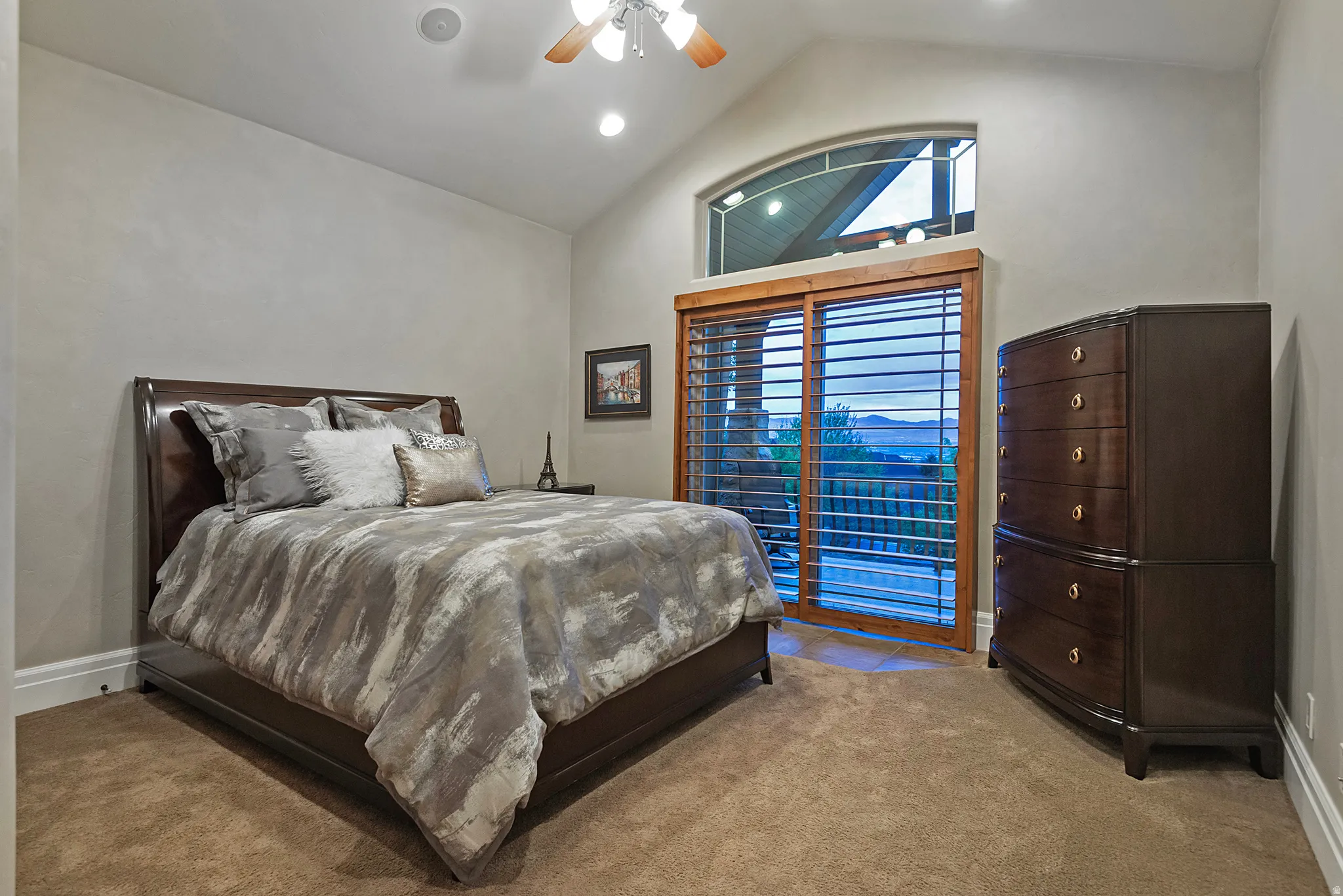 Carpeted bedroom featuring a high ceiling, a ceiling fan, and recessed lighting