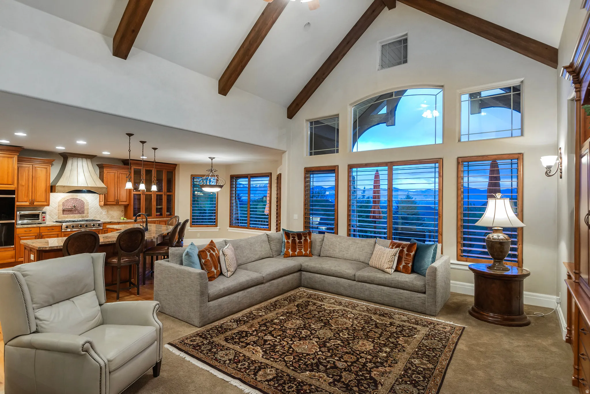 Living area with dark carpet, lofted ceiling, and recessed lighting