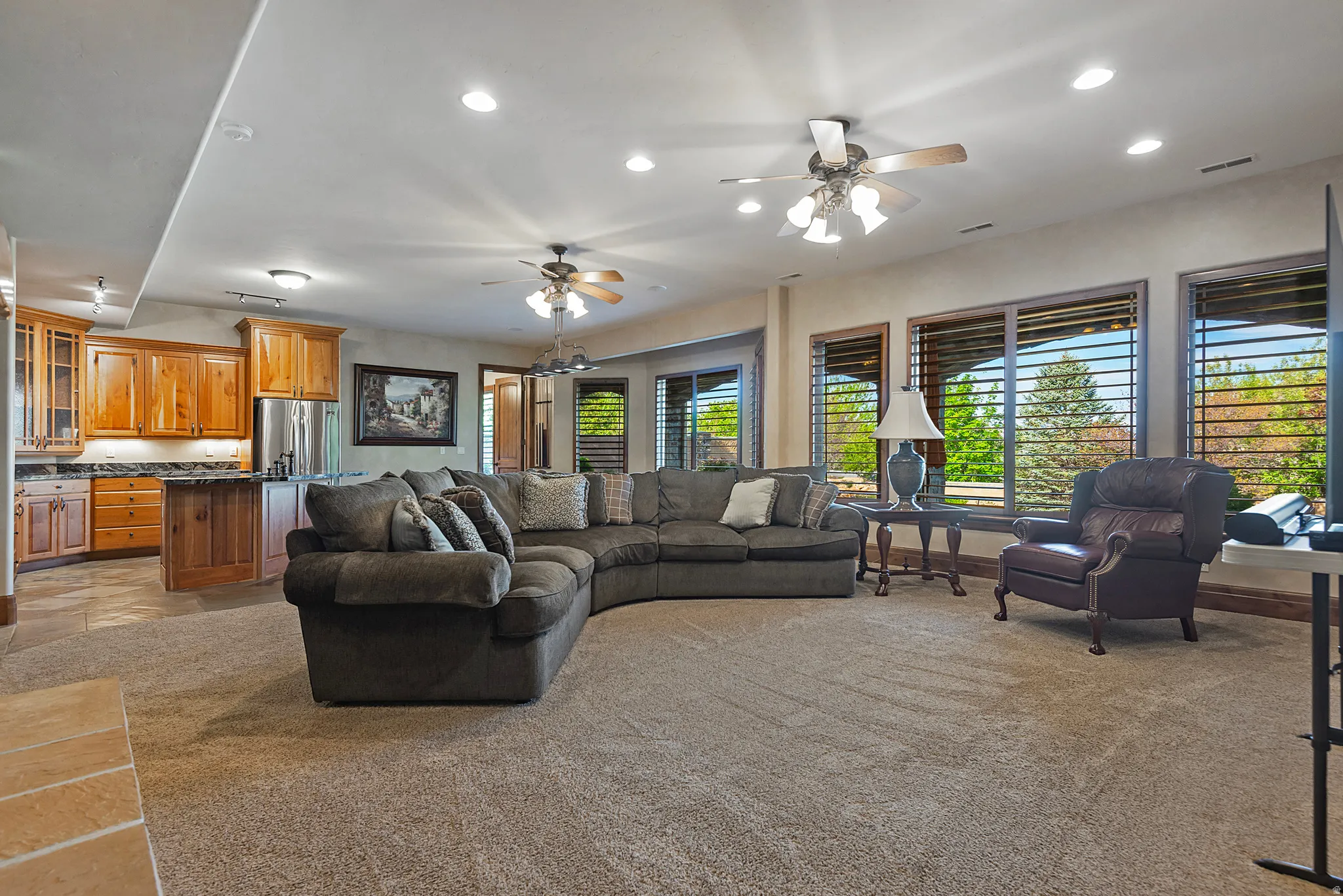 Living area featuring recessed lighting, light carpet, and ceiling fan