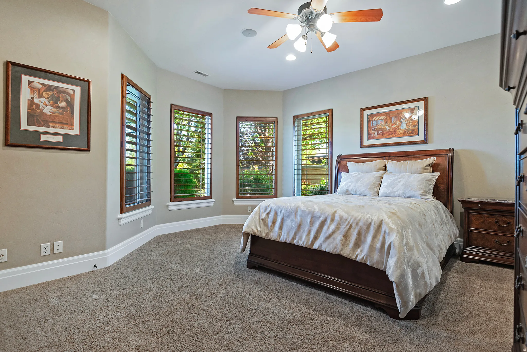 Carpeted bedroom with ceiling fan and recessed lighting